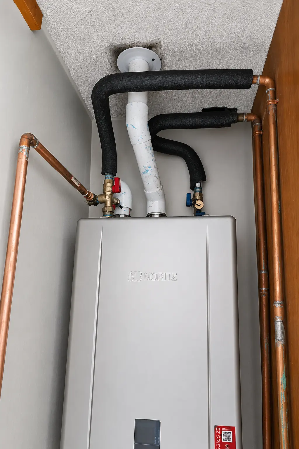 Copper piping and insulated connections on tankless water heater