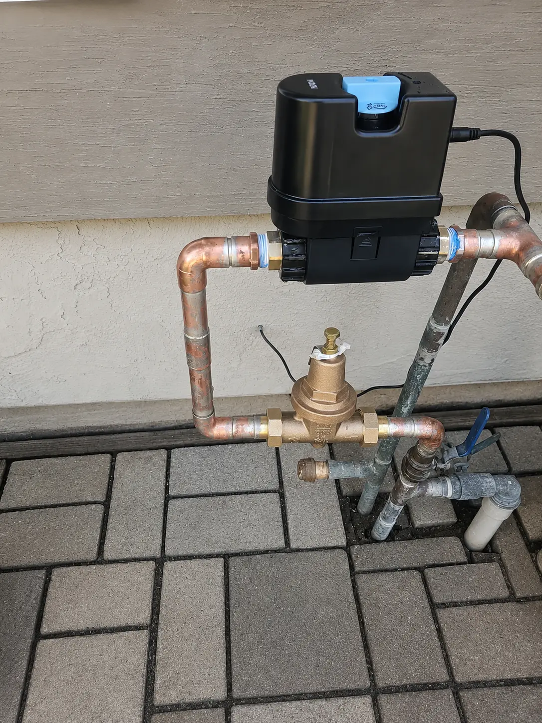 Close-up of smart shut-off and pressure regulator connections
