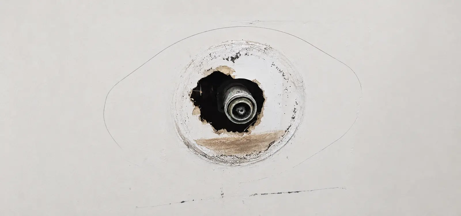 Shower valve visible through a small service opening